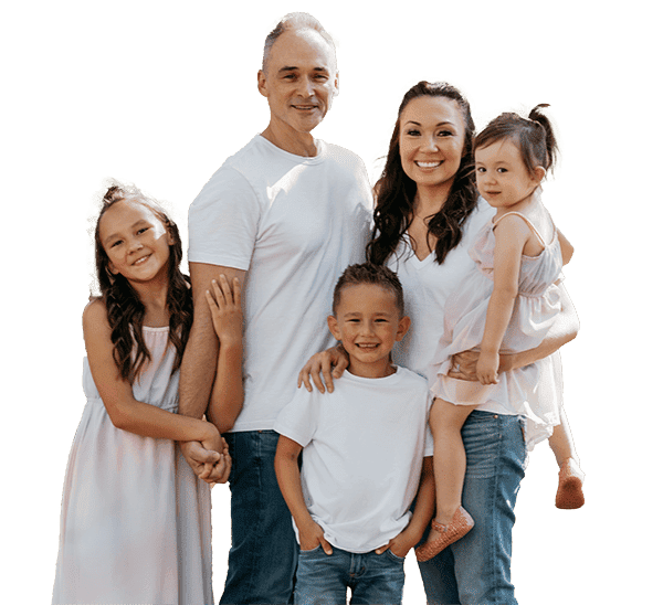 At Stellar Orthodontics in San Marcos, CA, a family of five—two adults and three smiling children dressed in casual, light-colored clothing—pose together.