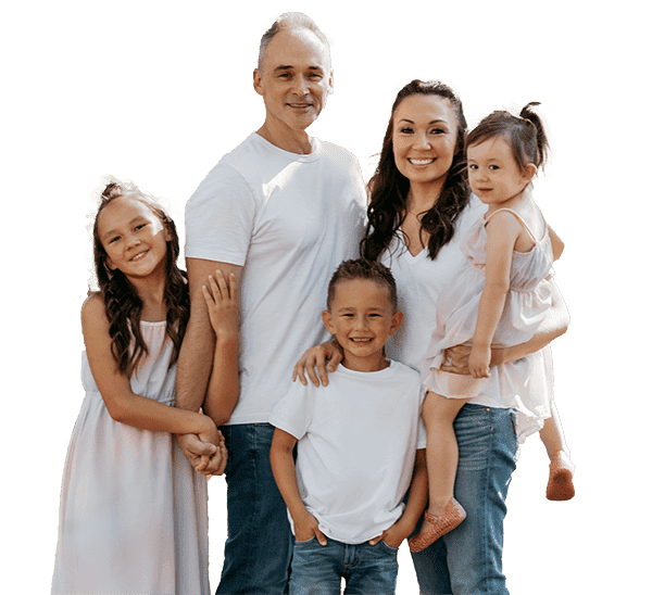 At Stellar Orthodontics in San Marcos, CA, a family of five—two adults and three smiling children dressed in casual, light-colored clothing—pose together.